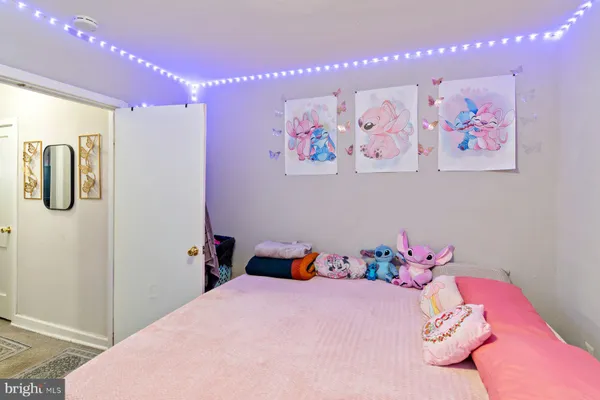 a bedroom with a bed and hallway