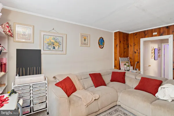 a living room with furniture and a painting