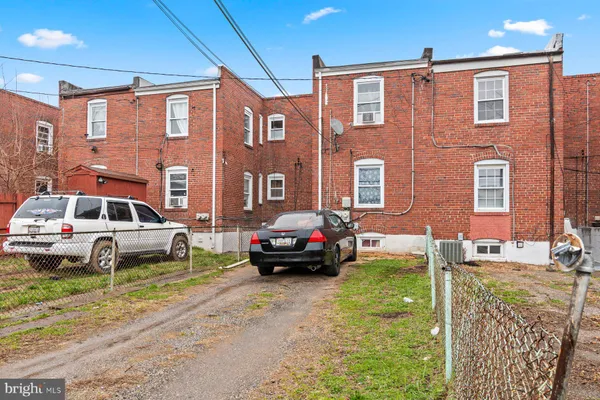 a car parked in front of a brick house