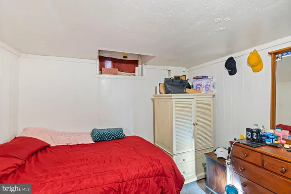 a bedroom with a bed and a dresser