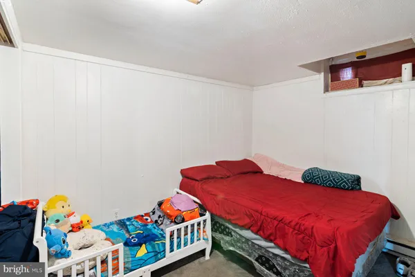 a bedroom with a bed and dresser