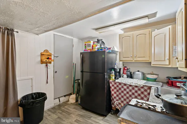 a kitchen with refrigerator and window