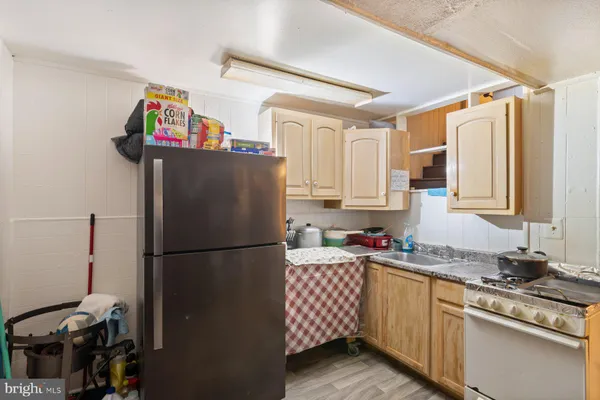 a kitchen with stainless steel appliances a refrigerator sink and cabinets