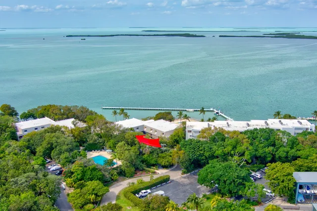 a kitchen with granite countertop a stove top oven microwave and cabinets
