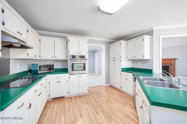 a kitchen with stainless steel appliances granite countertop a stove a microwave and cabinets