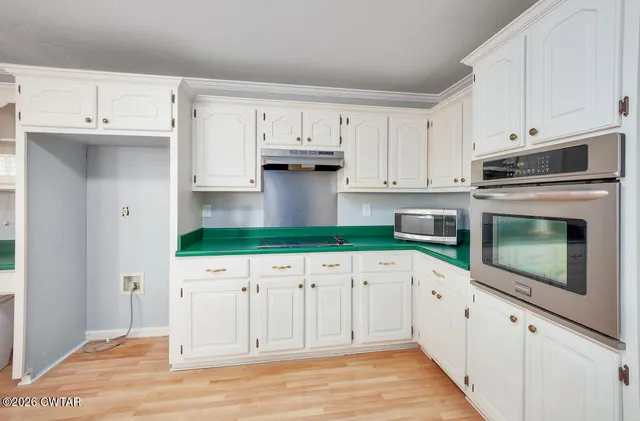 a view of kitchen with furniture and wooden floor