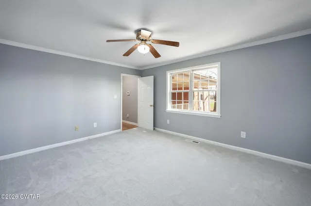 a spacious bathroom with a tub sink and mirror