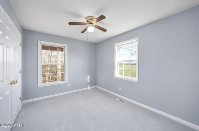a bathroom with a granite countertop sink mirror vanity and toilet