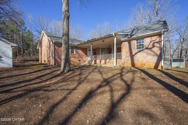 a view of a house with a yard and garage
