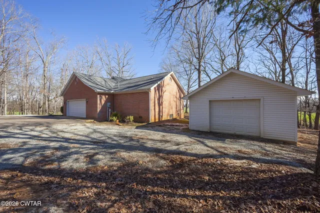 a view of a house with a yard covered in snow
