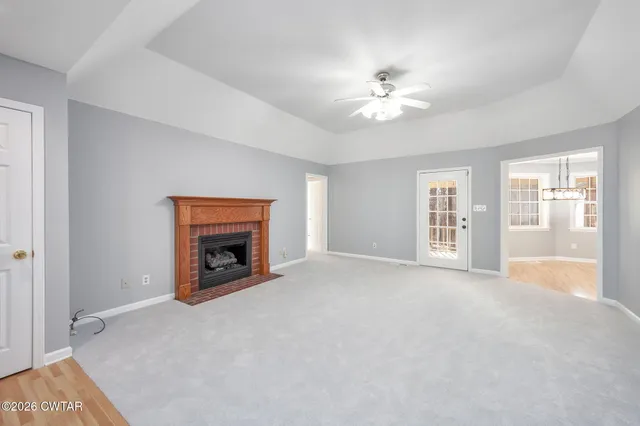 a view of an empty room with a fireplace