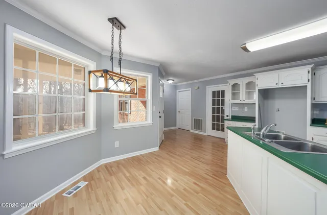 a kitchen with granite countertop a sink stove and cabinets