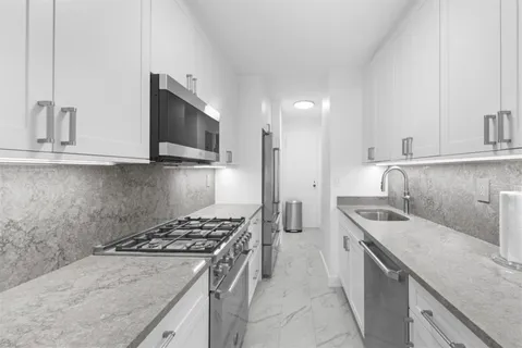 a kitchen that has a sink and a stove