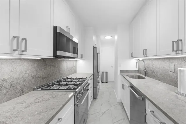 a kitchen that has a sink and a stove