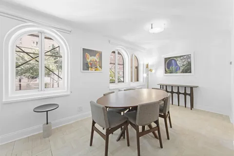 a view of a dining room with furniture and a window