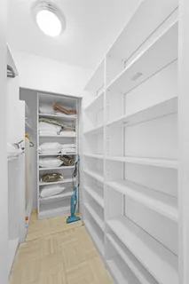 a view of walk in closet with empty racks