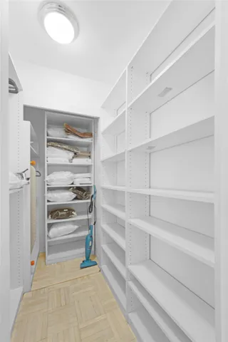 a view of walk in closet with empty racks
