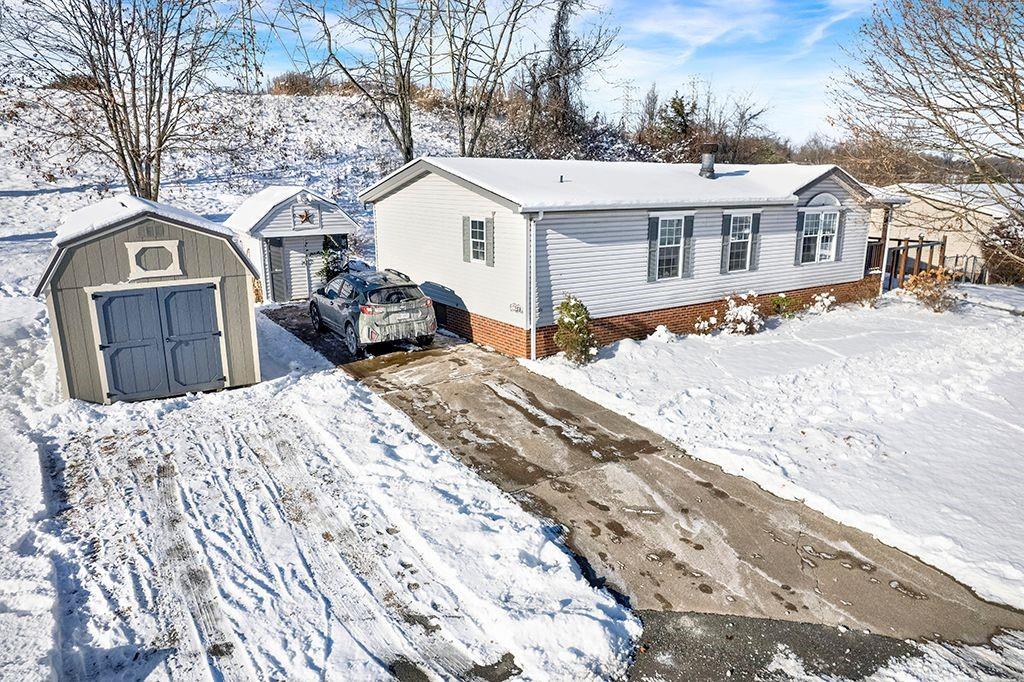 123 Laura Lane Elizabeth, PA 15037 - Photo 1 of 27 a front view of a house with a yard covered in snow