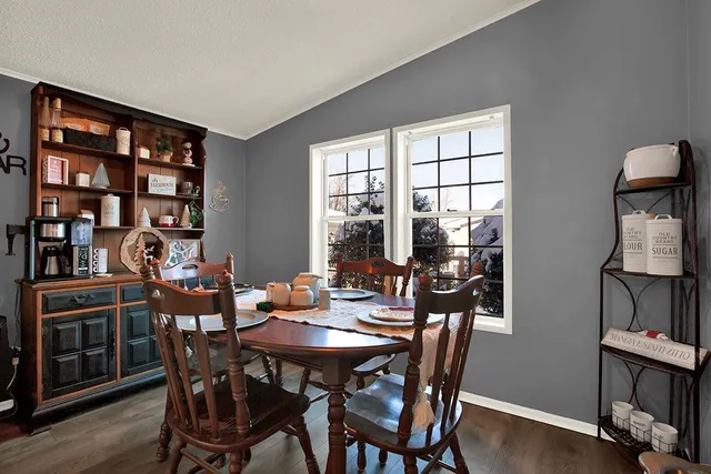 a view of a dining room with furniture and window