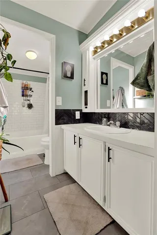 a bathroom with a granite countertop sink a mirror and a