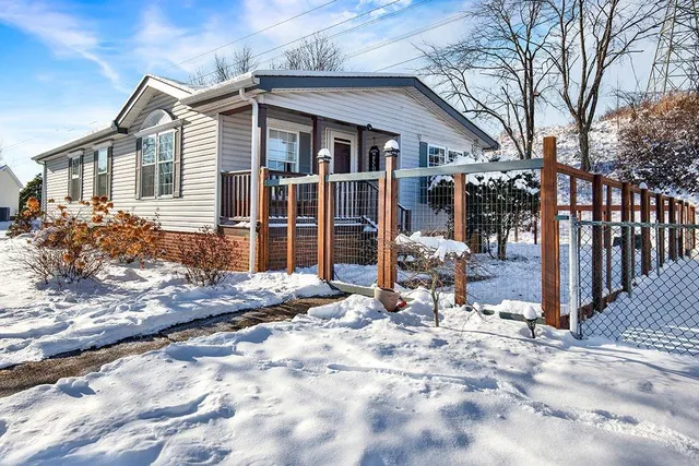 a view of a house with yard and sitting area