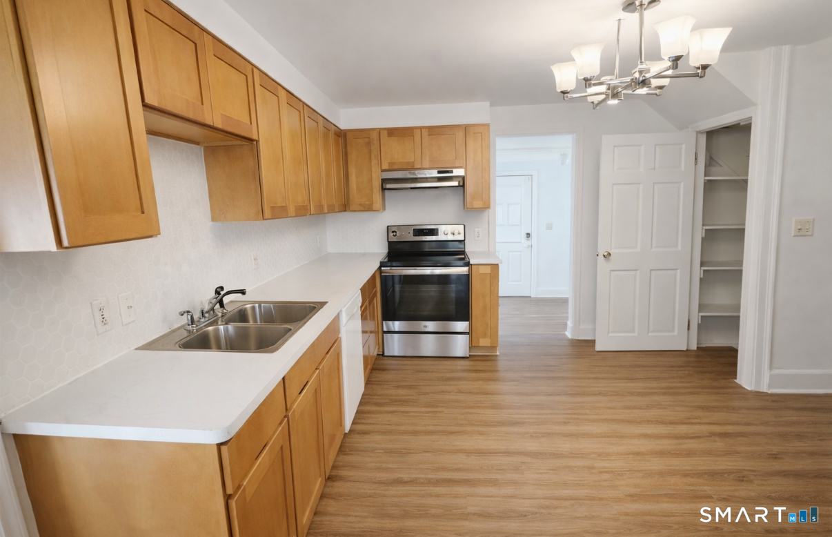 a kitchen with a sink and a stove top oven