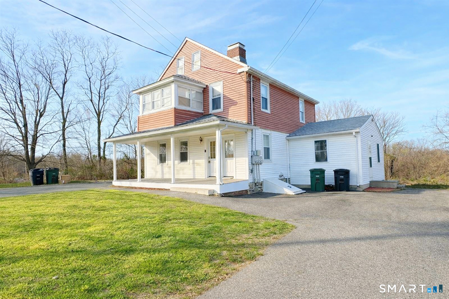 493 High Street Milford, CT 06461 - Photo 2 of 6 a view of a white house with a large windows and a yard