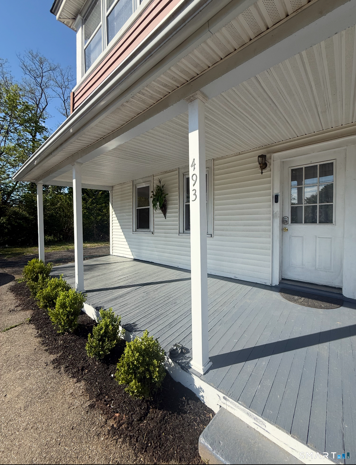 493 High Street Milford, CT 06461 - Photo 2 of 10 a house with flowers in front of it