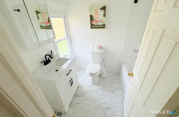 a bathroom with a sink a toilet and a mirror