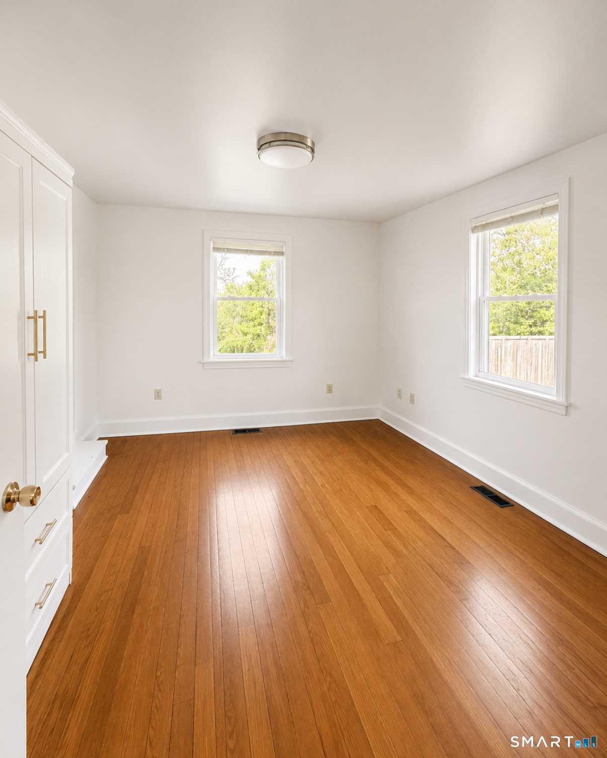 493 High Street Milford, CT 06461 - Photo 5 of 10 an empty room with wooden floor and windows