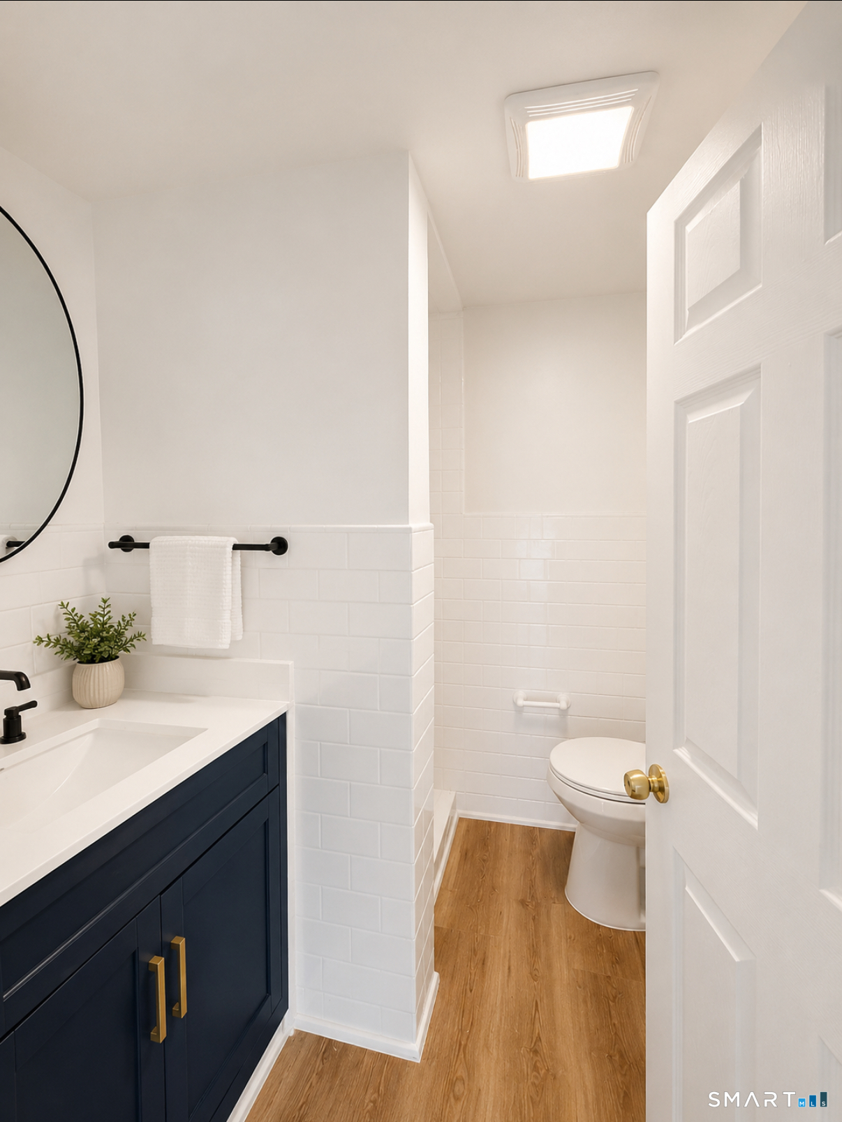 493 High Street Milford, CT 06461 - Photo 6 of 10 a bathroom with a sink a toilet and a mirror