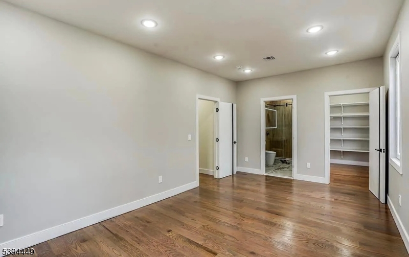 376 21st Street Irvington, NJ 07111 - Photo 15 of 24 a view of an empty room with a window and wooden floor