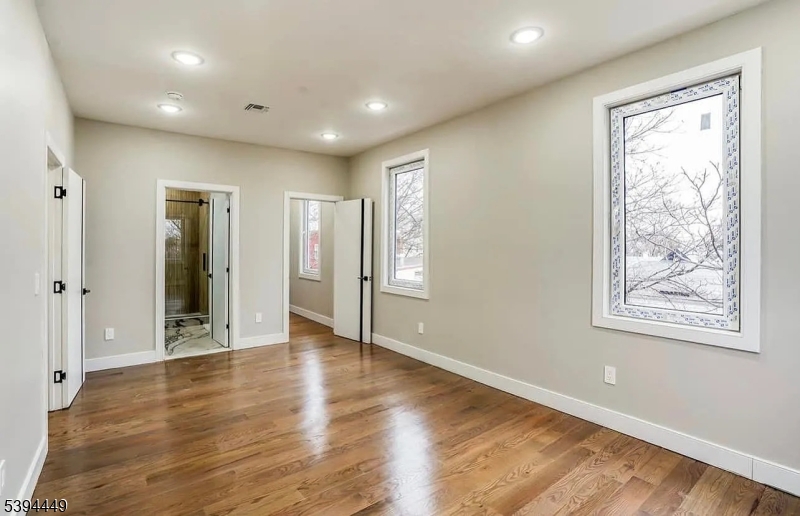 376 21st Street Irvington, NJ 07111 - Photo 20 of 24 a view of an empty room with wooden floor and a window