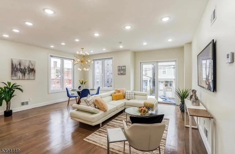 376 21st Street Irvington, NJ 07111 - Photo 5 of 24 a living room with furniture and a large window