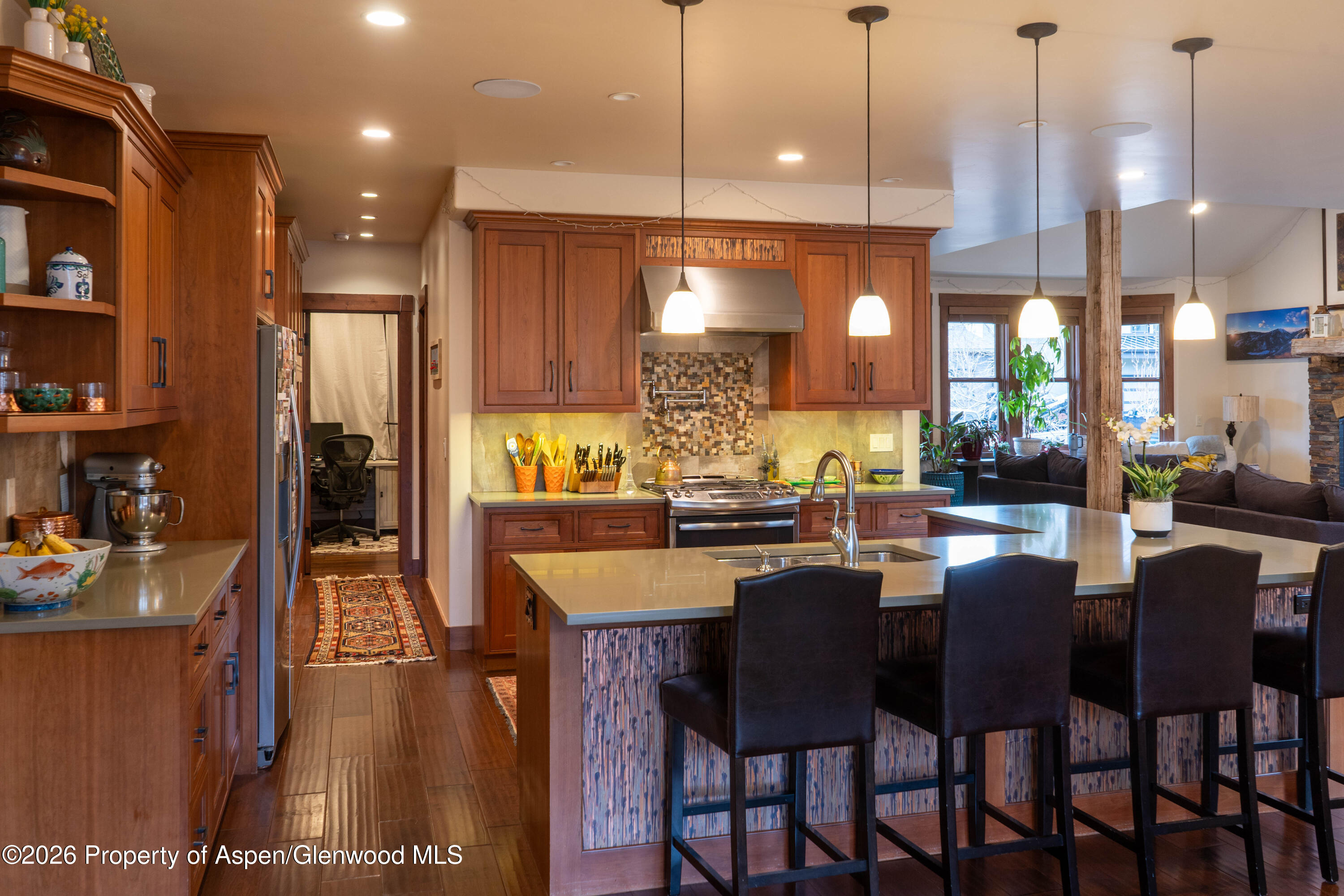 109 Valley Court Basalt, CO 81621 - Photo 13 of 41 a dining room with stainless steel appliances kitchen island granite countertop a table chairs and a refrigerator
