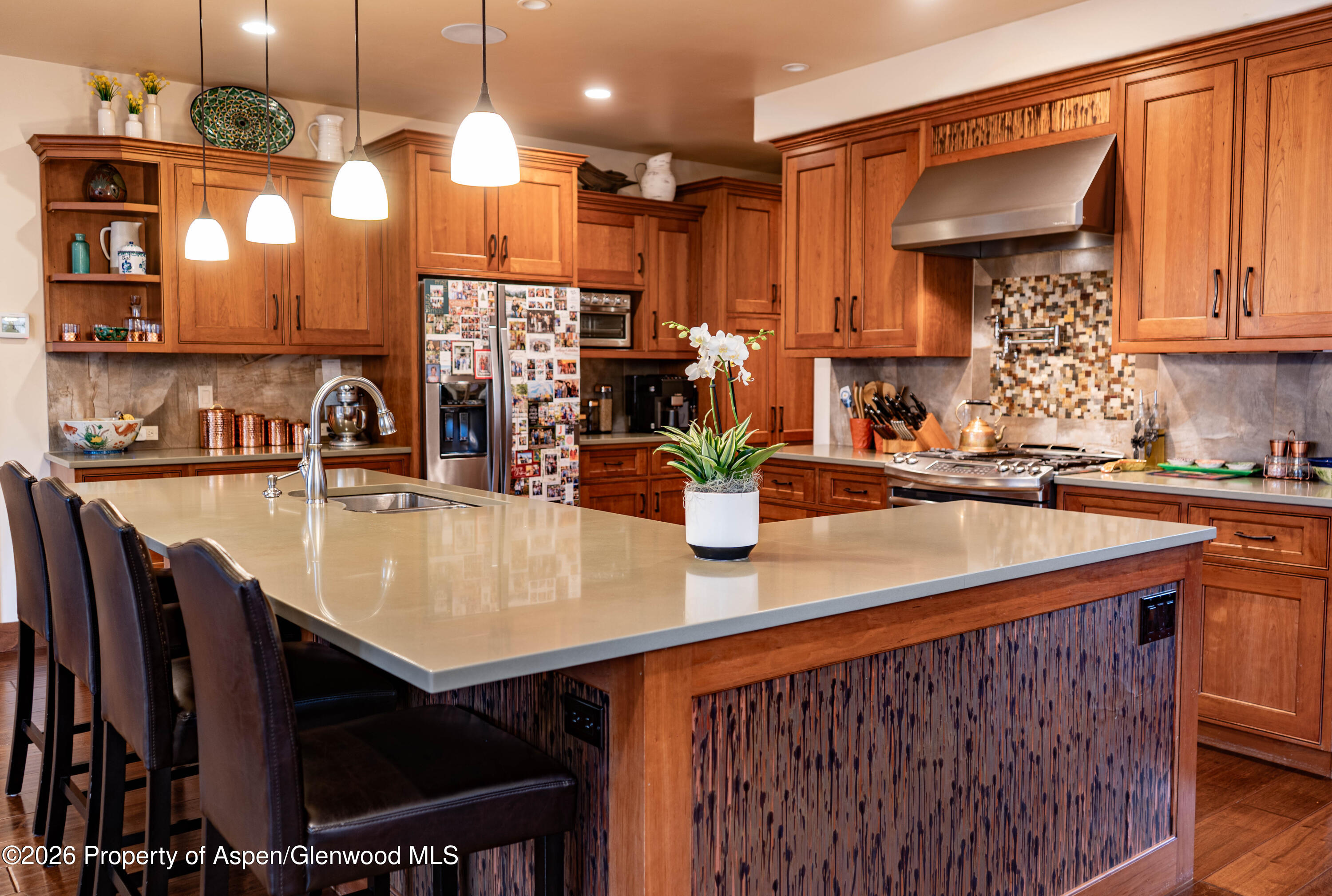 109 Valley Court Basalt, CO 81621 - Photo 4 of 41 a kitchen with stainless steel appliances kitchen island granite countertop a sink a table and chairs