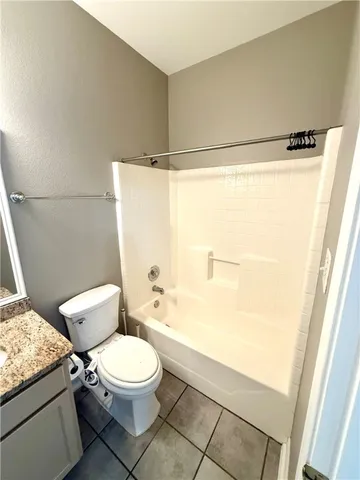 a white toilet sitting next to a bathroom sink