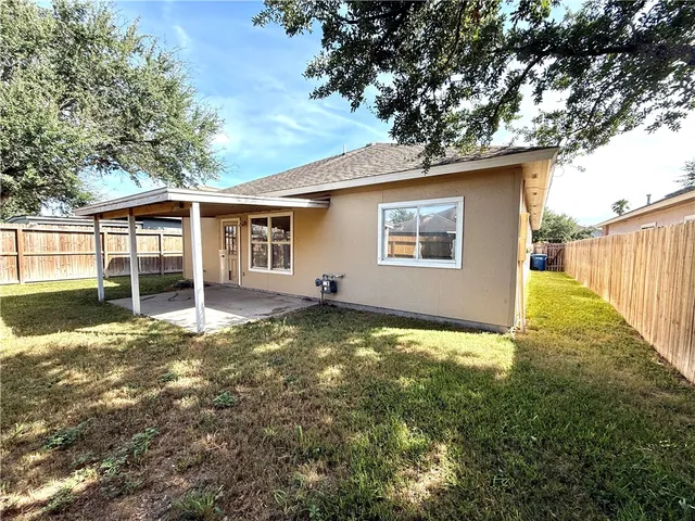 a backyard of a house with yard and outdoor seating