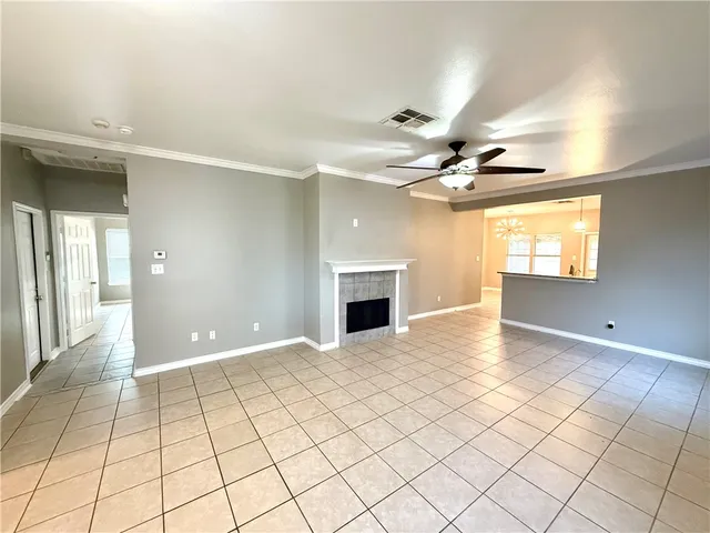 a view of a livingroom with a chandelier fan and windows
