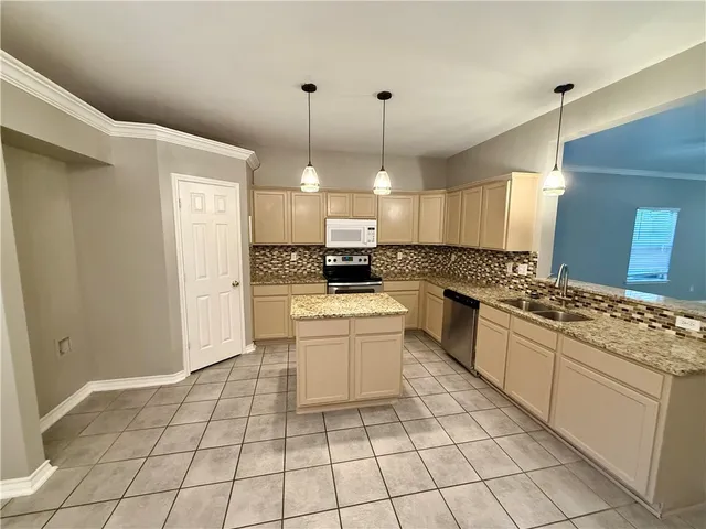 a kitchen with a stove a sink and a refrigerator