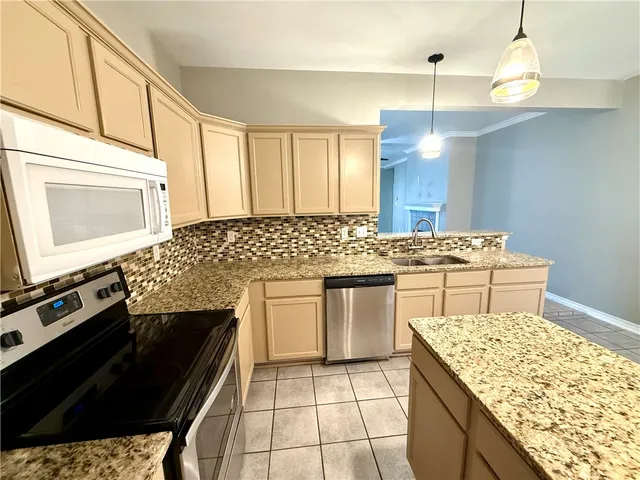 a kitchen with a stove sink and cabinets