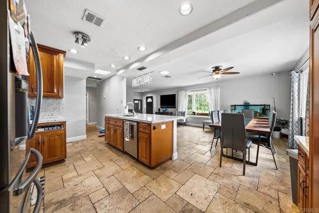 a living room with furniture a flat screen tv and a table