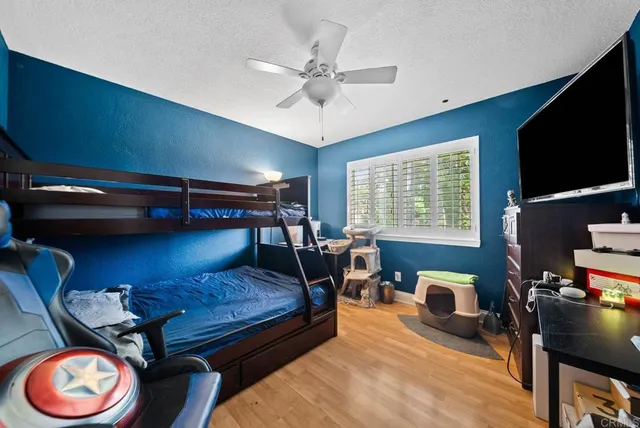 a bedroom with furniture and a flat screen tv