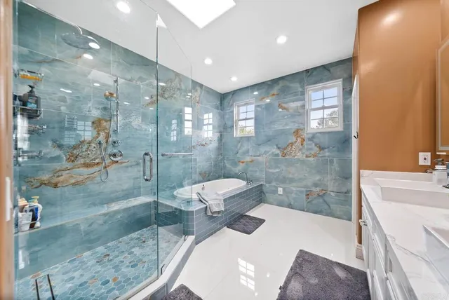 a bathroom with a sink a toilet and shower