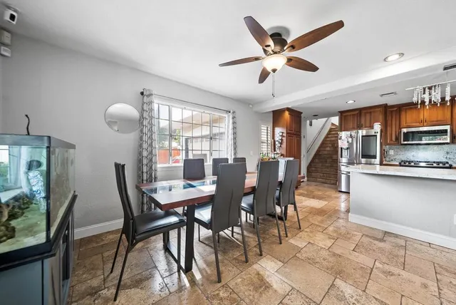 a dining room with furniture and window