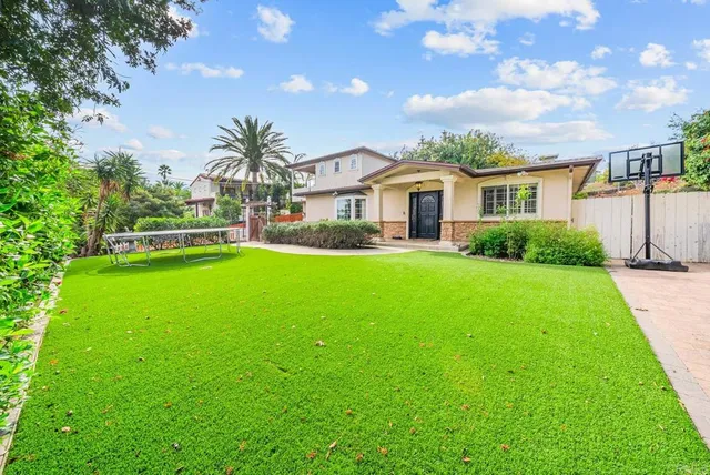a front view of house with yard and green space