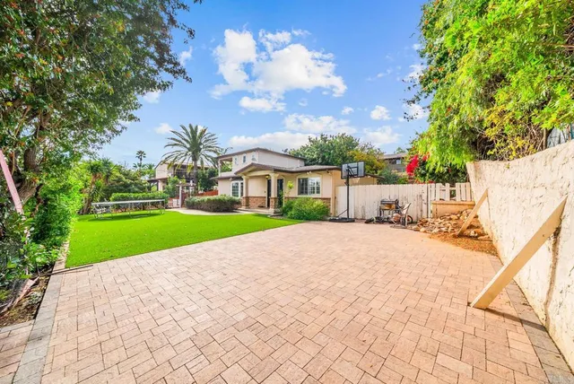 a view of house with yard and entertaining space