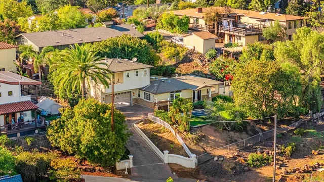 an aerial view of multiple houses with yard