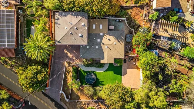 an aerial view of a house with a yard and garden