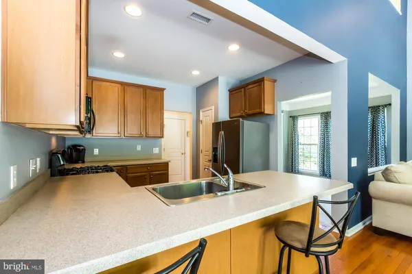 a kitchen with a table chairs and refrigerator